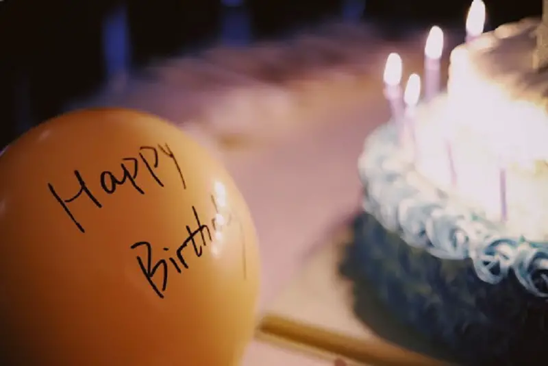 the words happy birthday written on a balloon, a blog pst on how to use a birthday name song maker